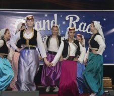 A group of women are dancing in front of a sign that says and race