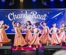 A group of young girls are dancing on a stage.