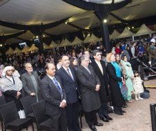 A group of people are standing in a line in a room.