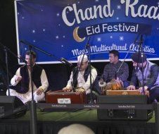 A group of men are playing musical instruments on a stage.