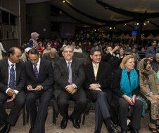 A group of people are sitting in chairs in a room.