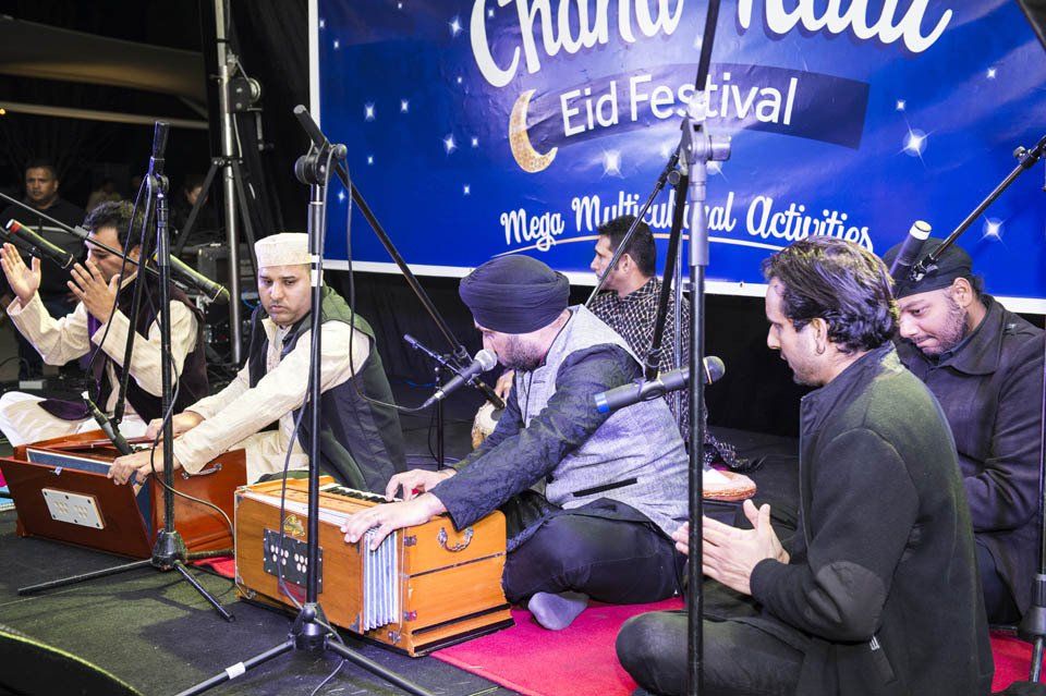 A group of men are playing musical instruments on a stage.