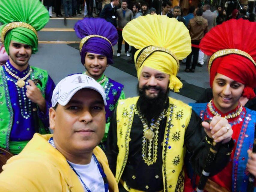A group of men wearing turbans are posing for a picture