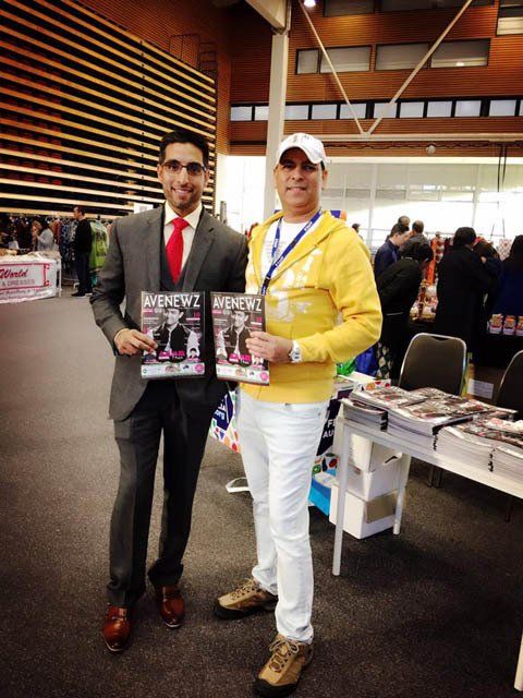 Two men are standing next to each other holding a magazine that says ' men ' on it