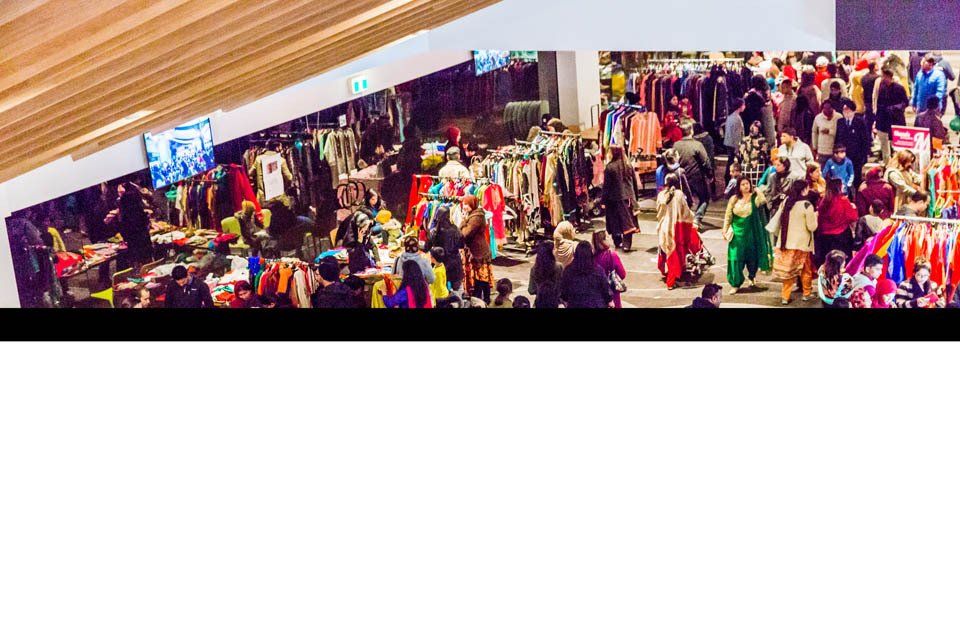 A large group of people are shopping in a mall.