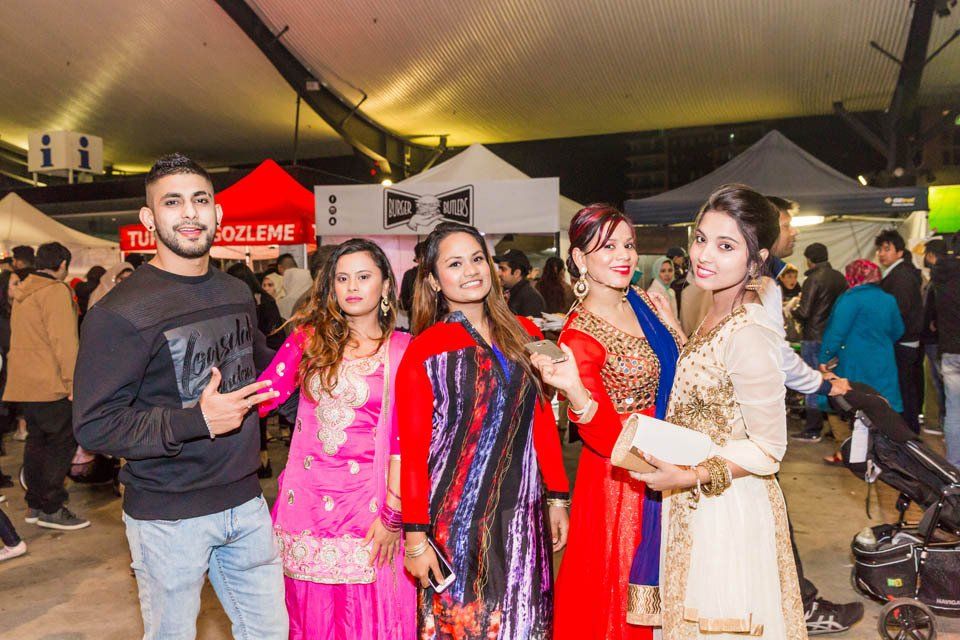 A group of people are posing for a picture at a festival.