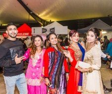 A group of people are posing for a picture at a festival.