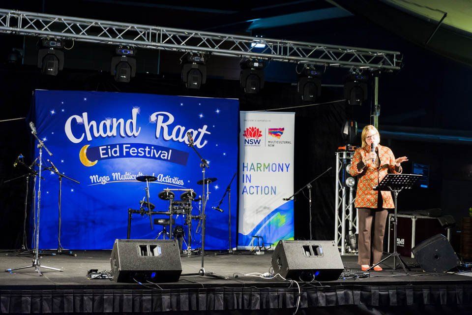 A woman singing on stage at the chand raat eid festival