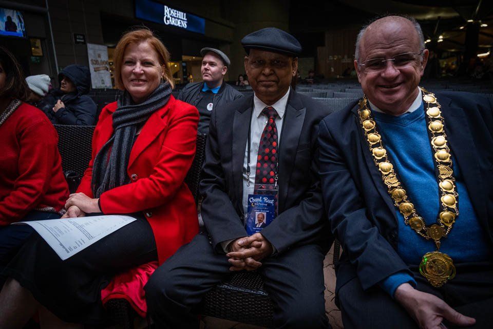 A group of people are sitting next to each other in a room.