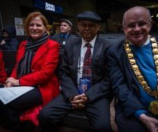 A group of people are sitting next to each other in a room.