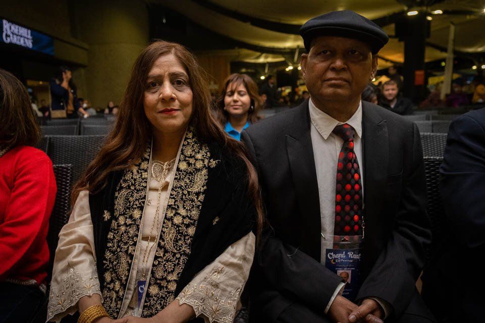 A man and a woman are sitting next to each other in a room.