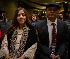 A man and a woman are sitting next to each other in a room.