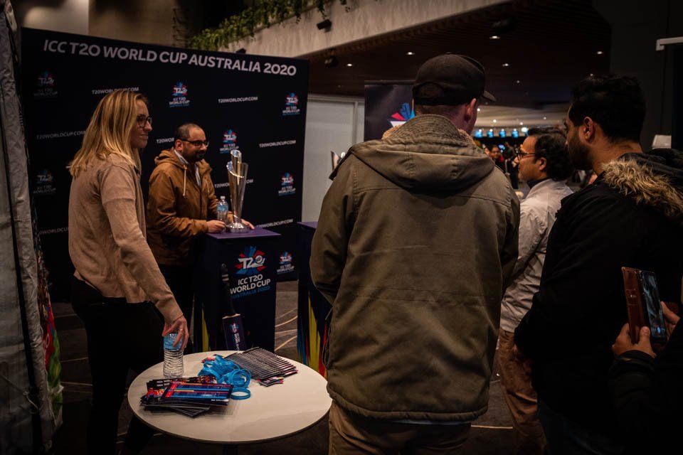 A group of people are standing around a table in a room.