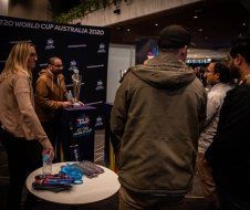 A group of people are standing around a table in a room.