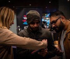 A group of people are standing next to each other in a room.