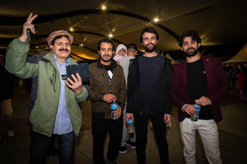 A group of men are standing next to each other in a room.