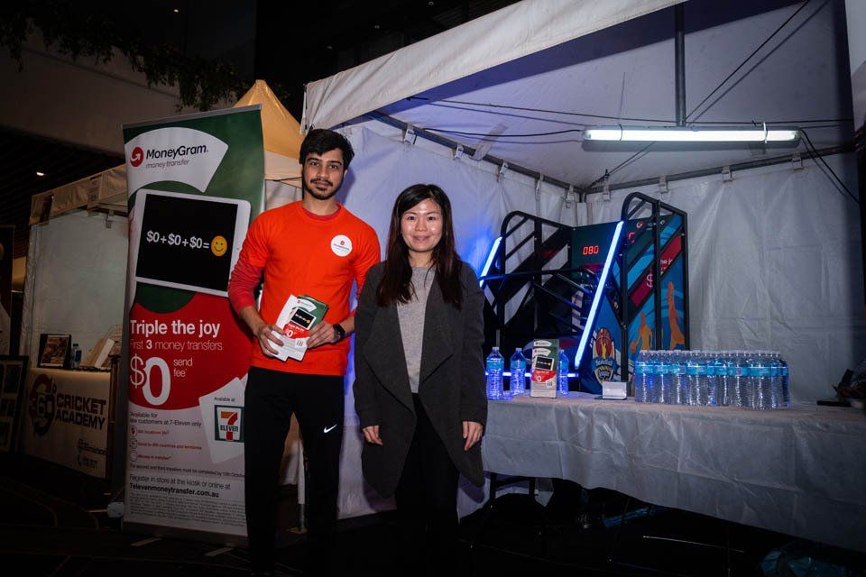 A man and a woman are standing next to each other in front of a tent.