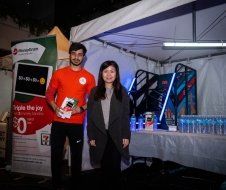 A man and a woman are standing next to each other in front of a tent.