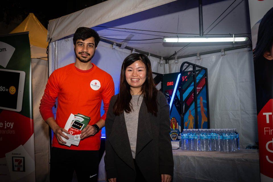 A man and a woman are standing next to each other in front of a tent.