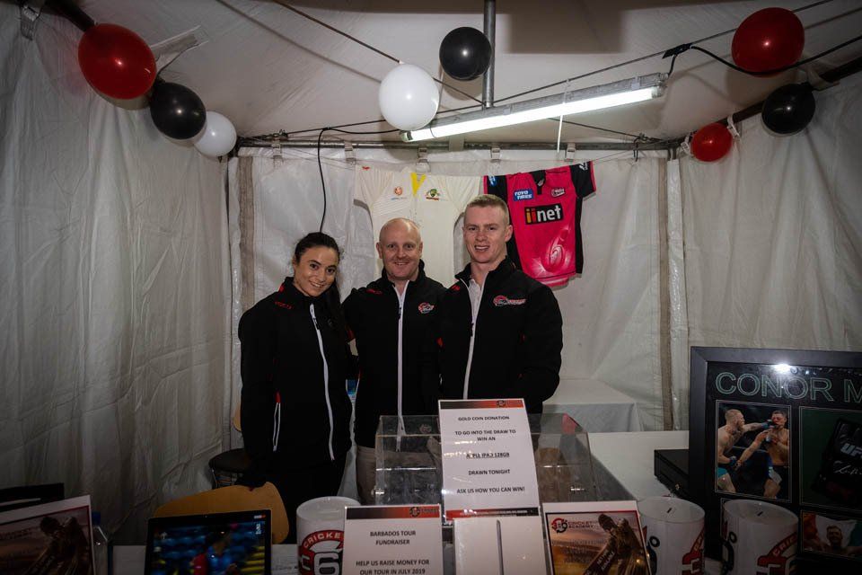 A group of people are posing for a picture in a tent.