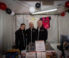 A group of people are posing for a picture in a tent.