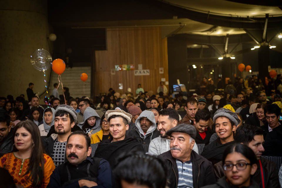 A large group of people are sitting in a room.