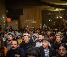 A large group of people are sitting in a room.