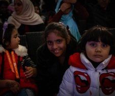 A group of young girls are sitting in a theater.