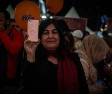 A woman is taking a picture of herself with her cell phone.