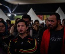 A group of people are standing in a room.