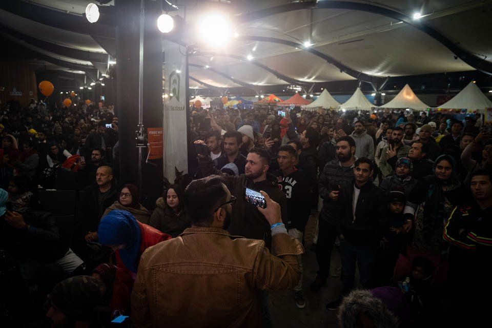 A man is taking a picture of a crowd of people.