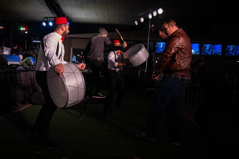 A group of men are playing drums on a stage.