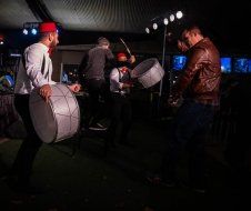 A group of men are playing drums on a stage.