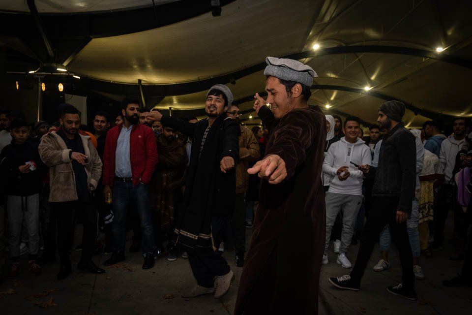 A man is dancing in front of a crowd of people.