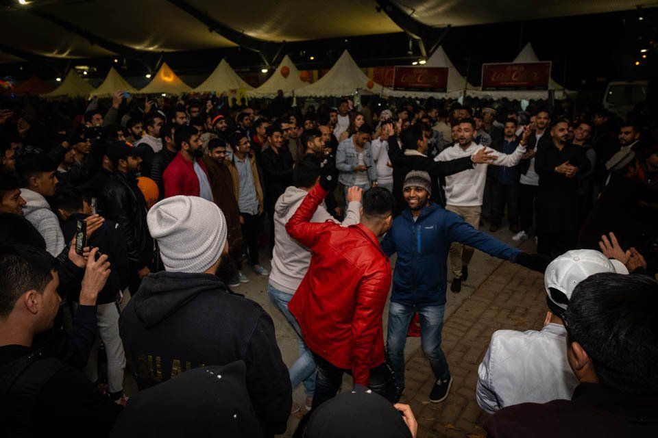 A group of people are dancing in a crowd at a party.