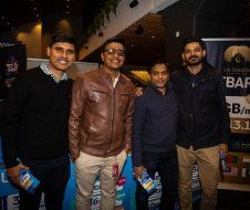 A group of men are standing next to each other in a room.