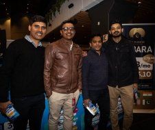 A group of men are standing next to each other in a room.