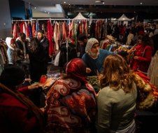 A group of people are shopping at a clothing store.