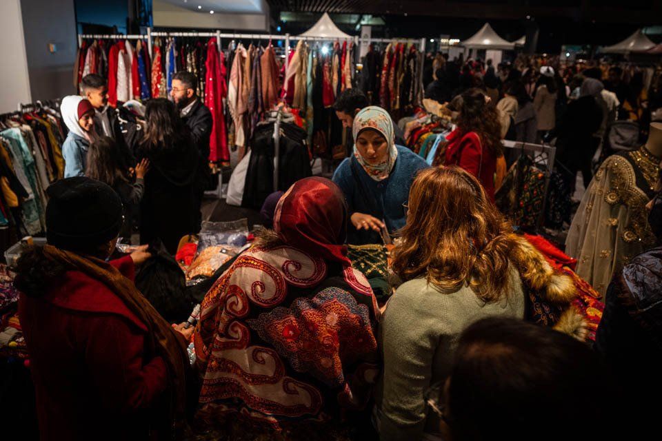 A group of people are shopping at a clothing store.