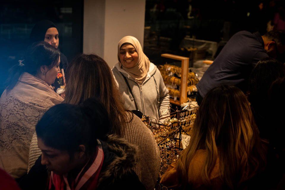 A group of people are standing around a table in a room.