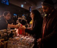A man and a woman are shopping at a market.