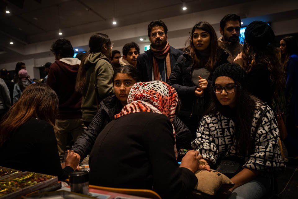 A group of people are sitting around a table in a room.