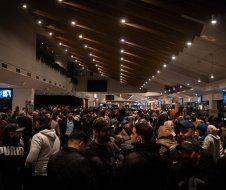 A large crowd of people are standing in a large room.