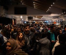 A large group of people are standing in a room.