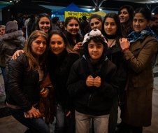 A group of young people are posing for a picture together.