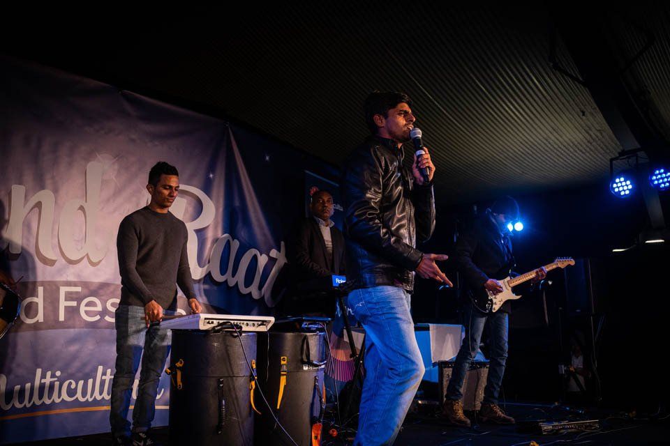 A man is standing on a stage holding a microphone.