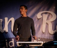 A man is standing in front of a large sign that says unr