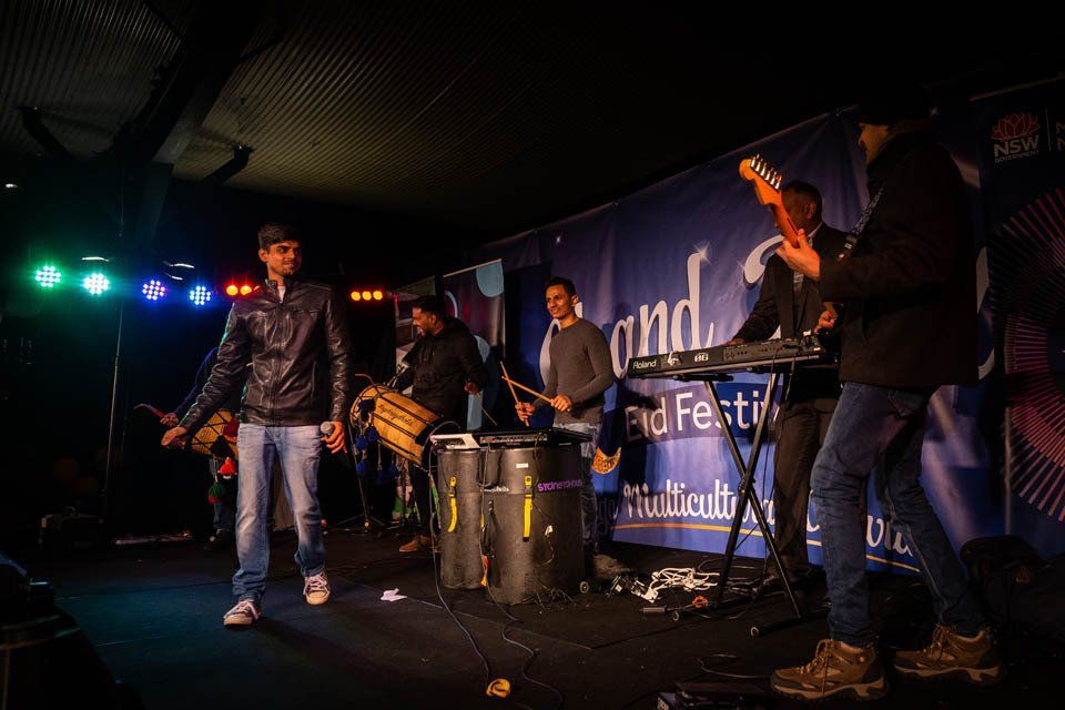 A group of men are playing instruments on a stage.