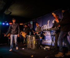 A group of men are playing instruments on a stage.