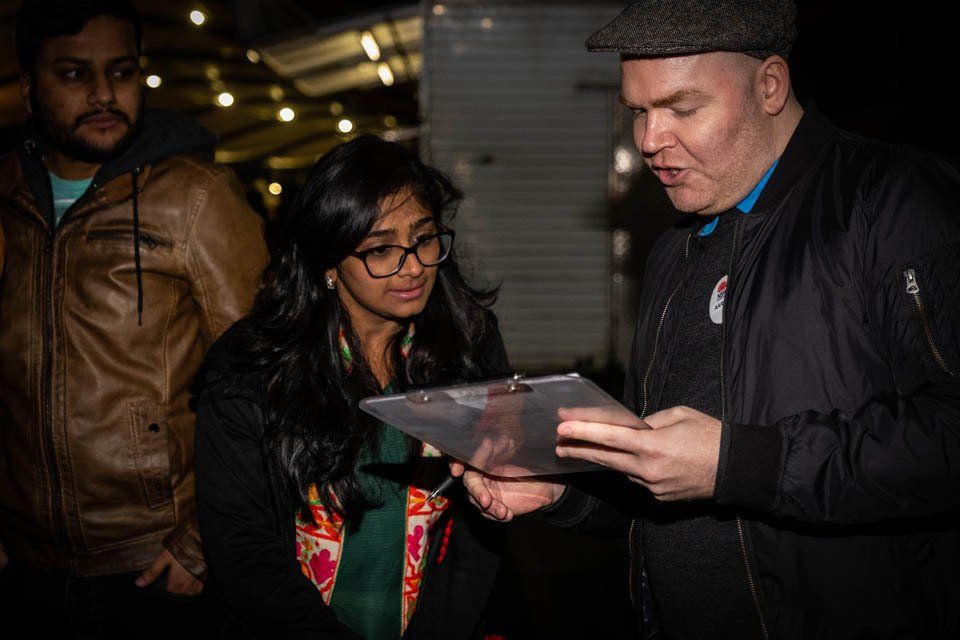 A man and a woman are looking at a piece of paper.